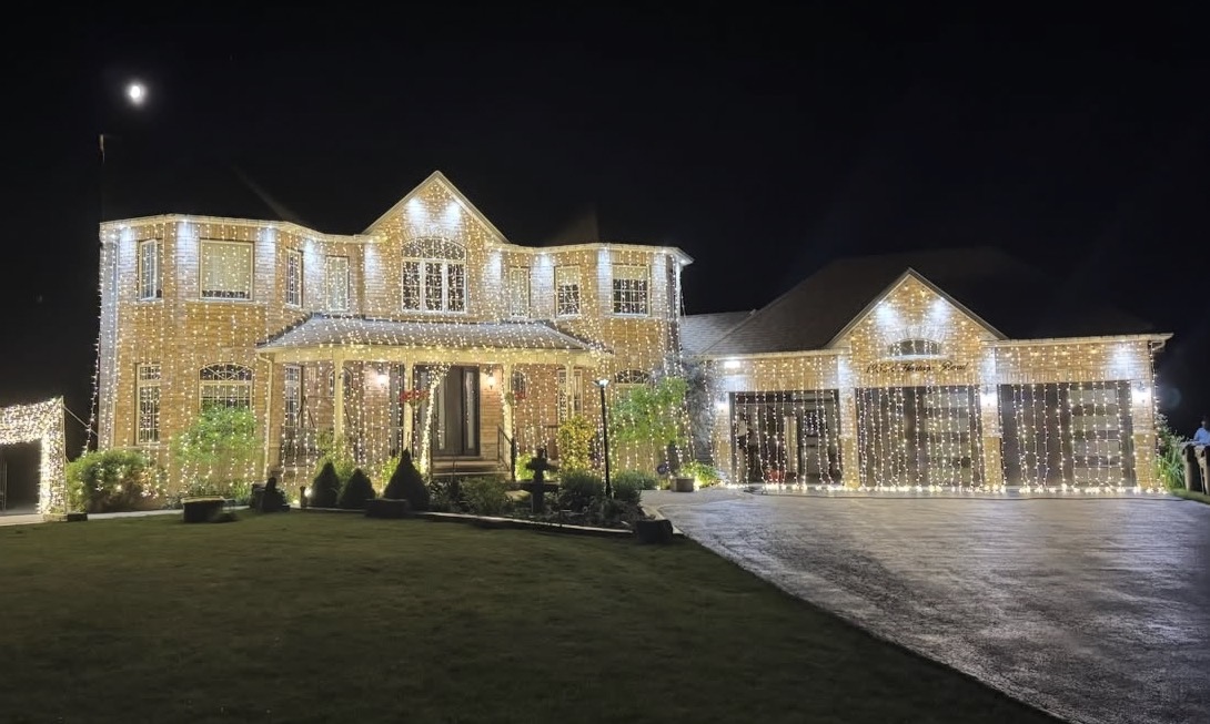 Large home decorated with event lighting